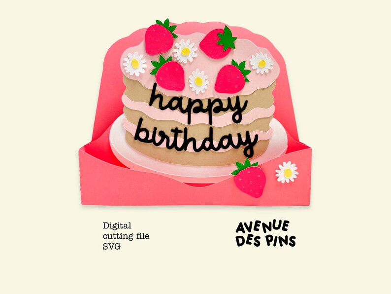 May include: A layered paper cake with pink frosting, strawberries, and daisies, with the words "happy birthday" in black script. The cake sits on a white plate within a pink card. The words "AVENUE DES PINS" are also visible.