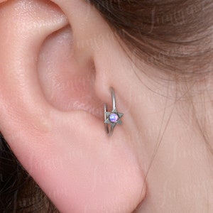 Tragus earring. Cartilage earring hoop. Forward helix earring. Conch ring. Rook earring hoop. Surgical steel cartilage hoop. Clicker hoop.