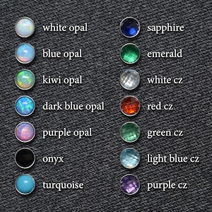 May include: A chart of different colored gemstones and opals, including white opal, sapphire, blue opal, emerald, kiwi opal, white cz, dark blue opal, red cz, purple opal, green cz, onyx, light blue cz, turquoise, and purple cz.