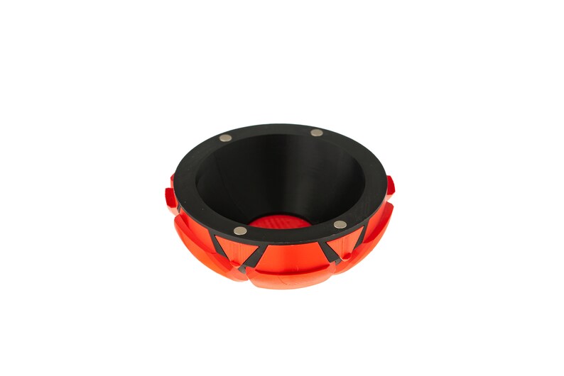 May include: A red and black bowl with a geometric design. The bowl has a black interior and a red exterior with black accents. The bowl is made of a durable material and is perfect for holding small items.