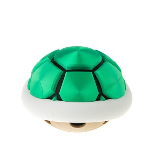 May include: A green and white shell with a segmented, dome-shaped top. The shell is a popular item in video games.
