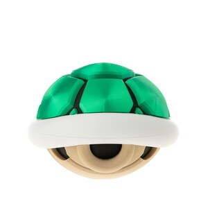 May include: A green and white shell-shaped object with a textured surface. It is a video game character from the Super Mario franchise.