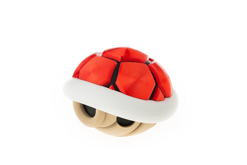 May include: A red and white shell with a brown base. The shell is a popular item in the Super Mario video game series.