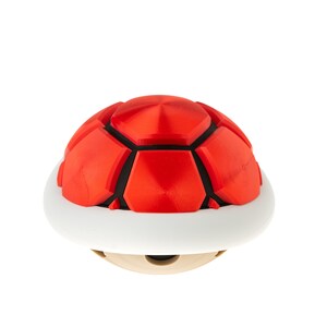 May include: A red and black shell with a white base. The shell is a popular item in video games.