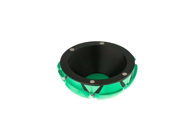 May include: A green and black bowl with a geometric design. The bowl has a black interior and a rim with four silver metal accents.