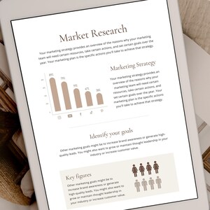 May include: A digital tablet displaying a marketing strategy document with a chart showing the percentage of people using different social media platforms. The document also includes text about identifying marketing goals and key figures.