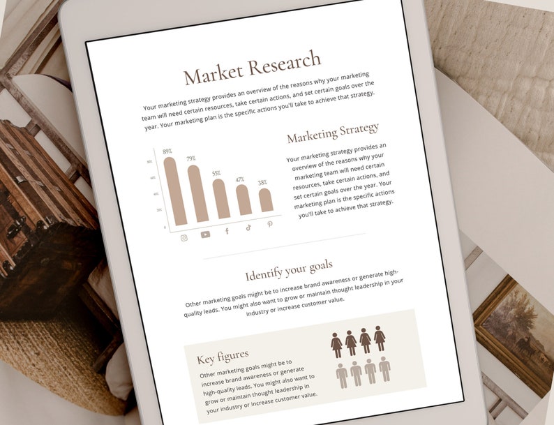 May include: A digital tablet displaying a marketing strategy document with a chart showing the percentage of people using different social media platforms. The document also includes text about identifying marketing goals and key figures.