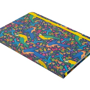 May include: A blue notebook with a colorful pattern of birds and flowers. The notebook has a yellow elastic band closure.