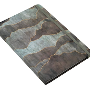 May include: A gray and blue notebook with a gold abstract pattern and a gray elastic closure.