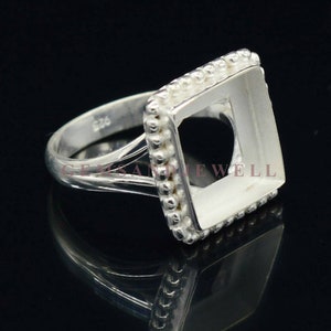May include: Silver ring with a square bezel setting. The bezel is decorated with small beads around the edge. The ring is sized 8.25.