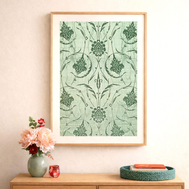 May include: A framed print featuring a repeating floral pattern in shades of green on a light green background. The artwork is displayed in a wooden frame and is set against a neutral wall. The image is part of a home decor collection.