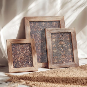 May include: Three wooden picture frames with a patterned design. The frames are arranged in a staggered formation, with the largest frame at the back and the smallest frame in the front. The frames are all made of natural wood with a rustic finish.