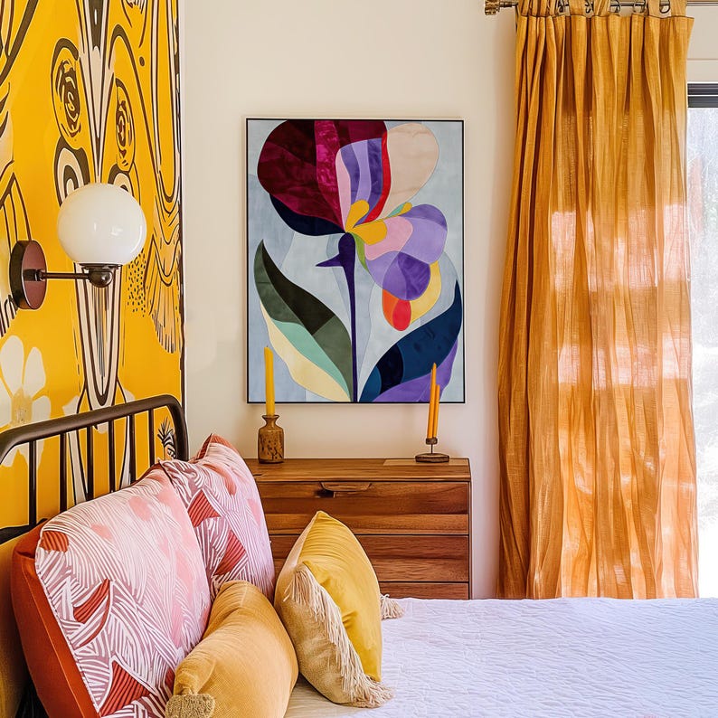 Abstract butterfly pea flower tapestry with burgundy, purple, light blue, and green hues, framed in light wood, displayed above a wooden dresser in a bedroom with yellow decor and patterned pillows.