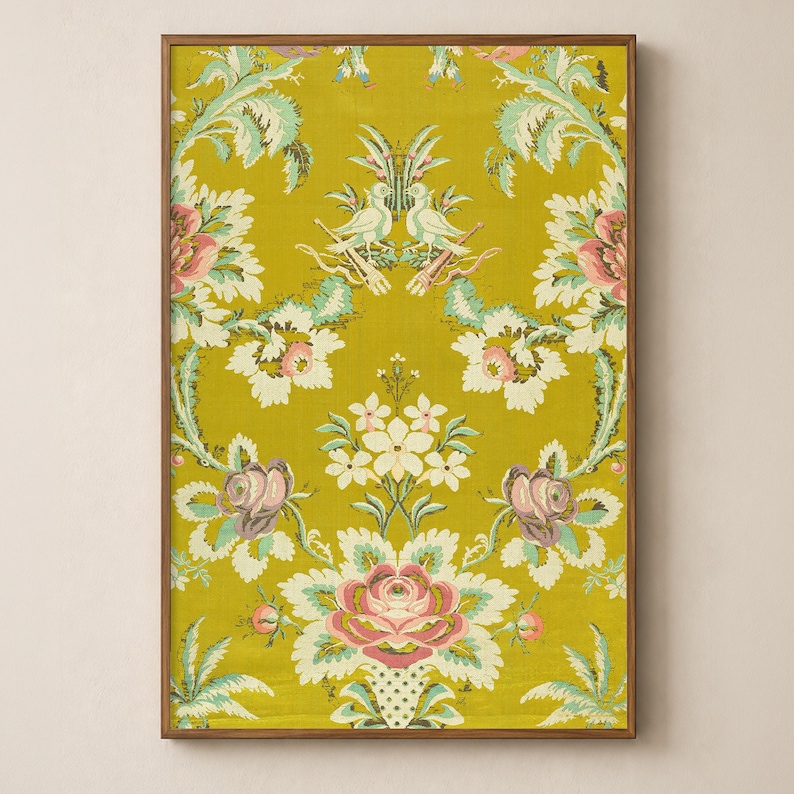 Antique French textile wall art artwork symmetrical floral pattern with bird emblem in chartreuse yellow in a sleek wood frame on a soft warm cream wall