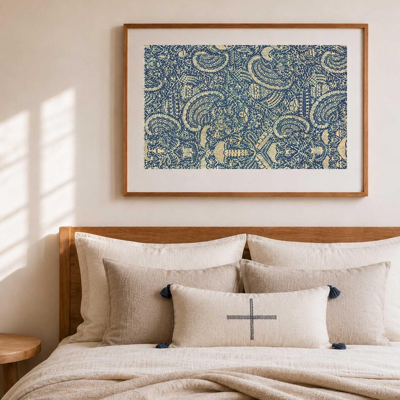 Framed horizontal crayfish pattern balinese fabric wall art print, on wall above a neutral styled linen bed in a modern bedroom