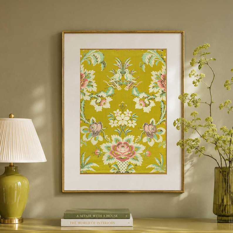Framed chartreuse French floral brocade textile print with cream mat and antique gold frame, styled in a soft olive interior with vintage books and glass vase