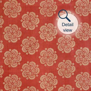 detail view of antique India block print textile wall art print showing repeat stencil folk medallion pattern in vermillion red and beige tones