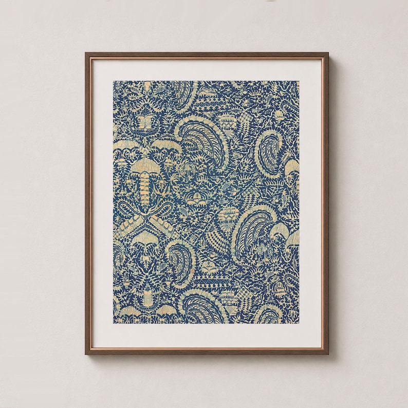 antique Indonesian Batik artwork with traditional crayfish motif in navy blue indigo and yellow cream in a sleek wood frame, with white mat, on a soft warm cream wall