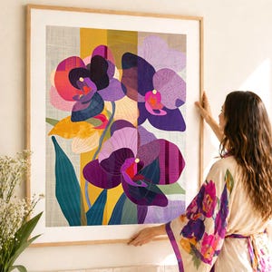 May include: A framed art print featuring a vibrant floral design. The artwork showcases stylized orchids in shades of purple, pink, and yellow, with detailed patterns and textures. The print is set within a light-colored wooden frame.