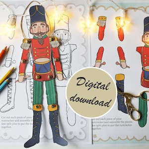 Peut inclure: Un kit de bricolage en papier imprimable représentant un casse-noisette soldat. Le kit comprend un contour du casse-noisette à colorier et des pièces séparées à découper et à assembler. Le texte sur la page indique "Découpez chaque pièce de votre casse-noisette et assemblez les pièces. Utilisez des punaises pour assembler le casse-noisette."