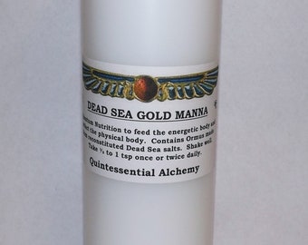 May include: White plastic bottle with a white label that reads "DEAD SEA GOLD MANNA" and contains information about the product. The label also includes the text "Quintessential Alchemy".