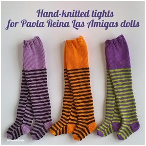 May include: Three pairs of hand-knitted tights for Paola Reina Las Amigas dolls. The first pair is light purple and dark purple striped, the second is orange and black striped, and the third is purple and lime green striped with ribbed cuffs.