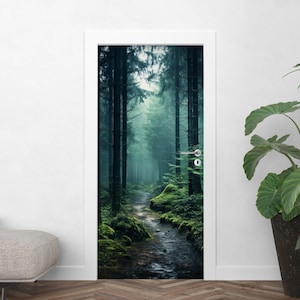 May include: A door wrap featuring a misty forest scene. The image shows a path winding through tall, dark trees with green moss and foliage. The artwork creates a serene and natural ambiance.
