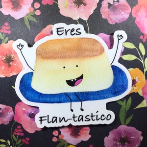 May include: A cartoon illustration of a flan dessert wearing a blue pool float and smiling. The text "Eres Flan-tástico" is written below the cartoon.