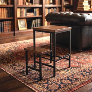 May include: A two-tier step stool featuring a dark brown wooden top and a lower wooden step, supported by a black metal frame. The structure consists of a taller rectangular section and a shorter, attached step, providing two levels of elevation.