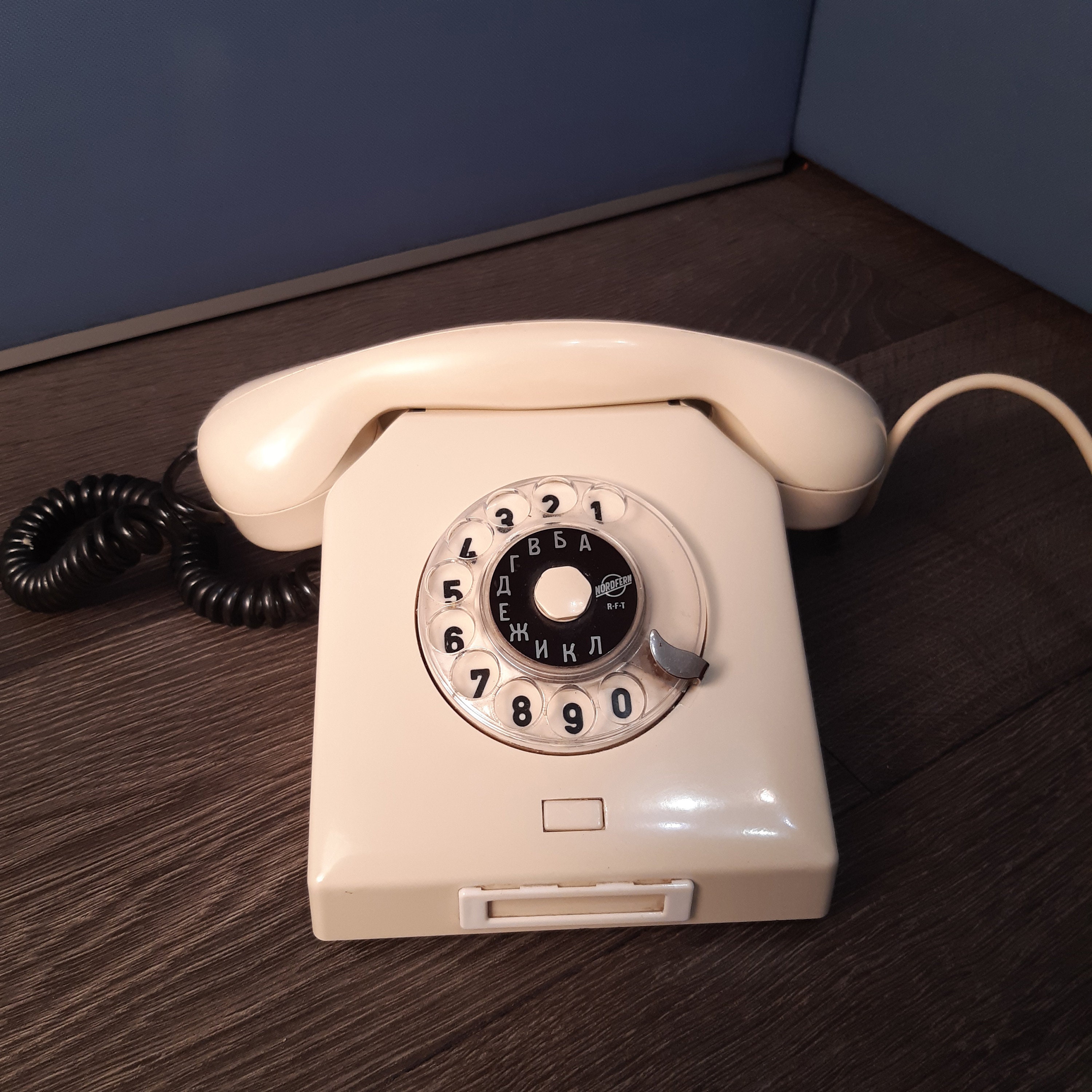 Details with a white old fashioned dial rotary phone from the