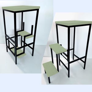 May include: A black metal step stool with a light green top and two steps. The stool is designed to be used as a step ladder.