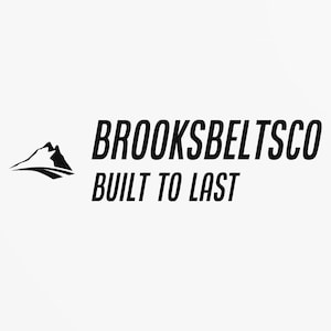May include: Black and white logo for Brooksbeltsco, a company that makes belts. The logo features a stylized mountain range and the text "BROOKSBELTSCO BUILT TO LAST".