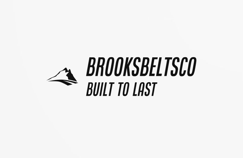 May include: Black and white logo for Brooksbeltsco, a company that makes belts. The logo features a stylized mountain range and the text "BROOKSBELTSCO BUILT TO LAST".