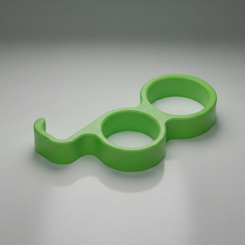 May include: A bright green, plastic, multi-functional tool. It features two circular finger holes and a curved hook on one end. The tool is designed to assist with opening doors and pressing buttons.