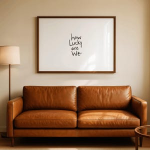 A minimalist wall art print featuring the quote “How Lucky Are We” in elegant hand-drawn typography on a neutral background. The modern canvas design exudes warmth and simplicity, perfect for couples who value love and gratitude. This inspirational quote poster adds a timeless touch to any contemporary or boho-style home. A beautifully crafted neutral wall decor piece that symbolizes appreciation, connection, and modern elegance.