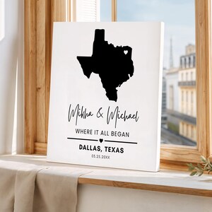 May include: A white canvas print featuring a black silhouette of the state of Texas with a heart marking a location. The print includes the names "Mikha & Michael", the phrase "WHERE IT ALL BEGAN", and the city "DALLAS, TEXAS" with a date.