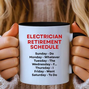 May include: A white ceramic mug with a black interior and handle. The mug features the text "ELECTRICIAN RETIREMENT SCHEDULE" in red, with a humorous daily schedule below. The mug is held by a person.