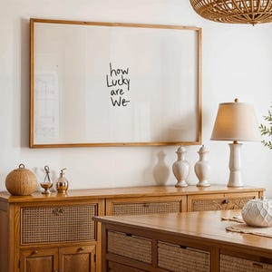 A minimalist wall art print featuring the quote “How Lucky Are We” in elegant hand-drawn typography on a neutral background. The modern canvas design exudes warmth and simplicity, perfect for couples who value love and gratitude. This inspirational quote poster adds a timeless touch to any contemporary or boho-style home. A beautifully crafted neutral wall decor piece that symbolizes appreciation, connection, and modern elegance.
