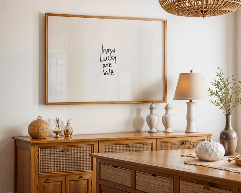 A minimalist wall art print featuring the quote “How Lucky Are We” in elegant hand-drawn typography on a neutral background. The modern canvas design exudes warmth and simplicity, perfect for couples who value love and gratitude. This inspirational quote poster adds a timeless touch to any contemporary or boho-style home. A beautifully crafted neutral wall decor piece that symbolizes appreciation, connection, and modern elegance.
