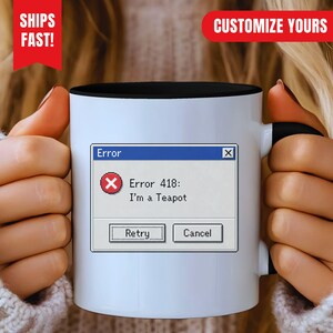 May include: A white ceramic mug with a black interior and handle, featuring a computer error message graphic that reads Error, Error 418: I'm a Teapot, with a red circle containing a white X, and two buttons labelled Retry and Cancel.