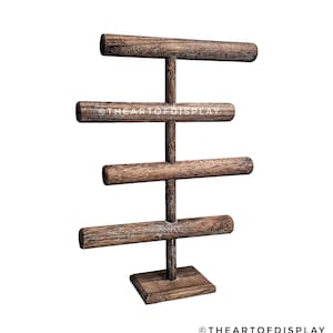 May include: Wooden bangle display stand with four tiers. The stand is made of dark brown wood with a distressed finish. The stand is designed to hold bracelets and bangles.