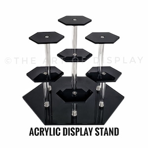 May include: Black acrylic display stand with six hexagonal shelves. The stand is made of clear acrylic and has a modern design.