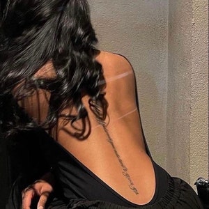 Long writing back tattoo