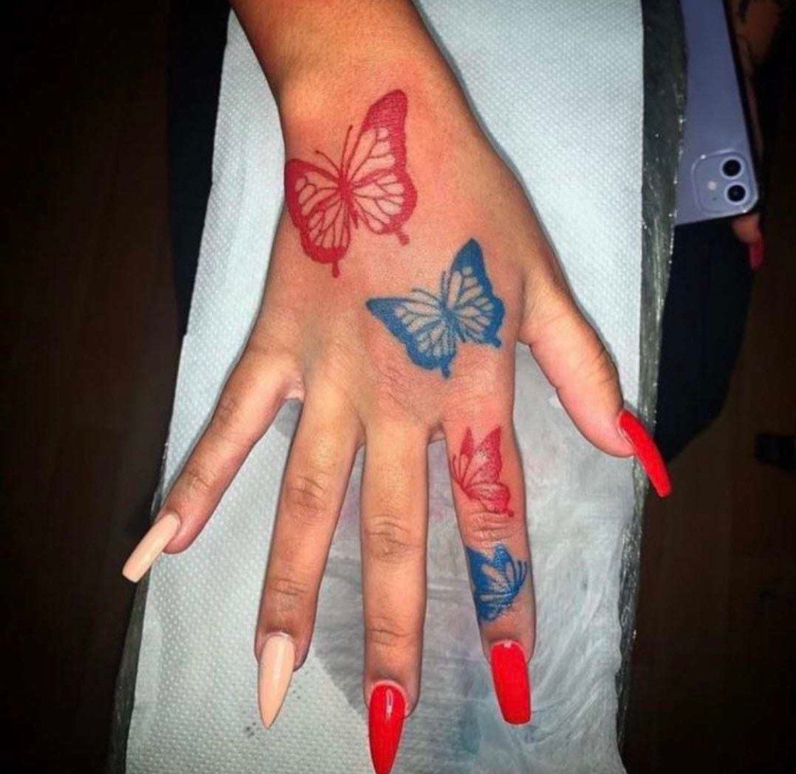 The Parlour tattoos  Red cherry blossom and butterfly hand tattoo by Lucy   Facebook
