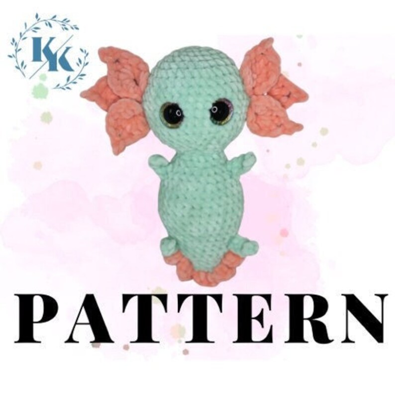 May include: Crochet amigurumi pattern for a green axolotl with pink gills. The pattern includes instructions for creating a cute and cuddly toy.