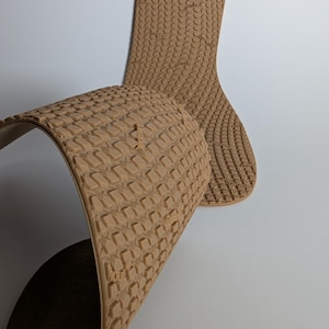 May include: Tan-colored shoe insoles with a textured, repeating pattern. The insoles are flexible and curved, with one insole partially folded over. The design includes the text "Dunk" on the insole.