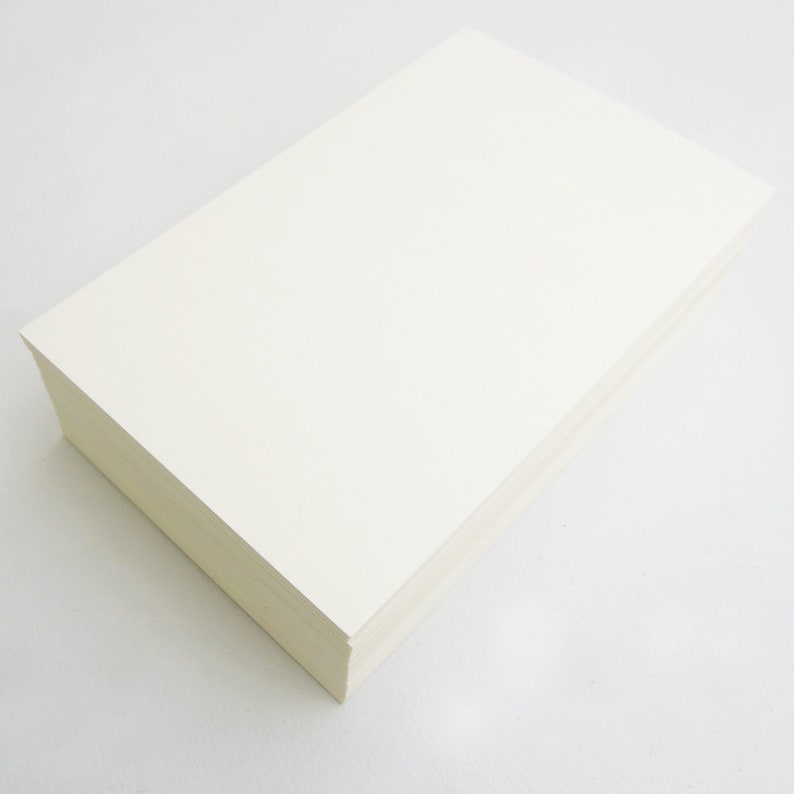 May include: A stack of white cardstock paper.