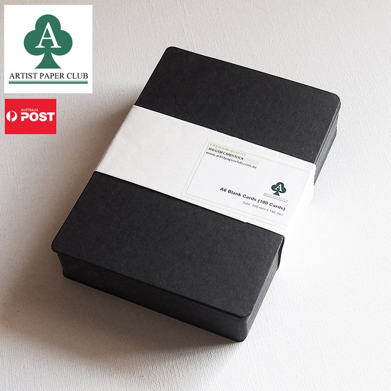 May include: A black box containing 100 A6 blank cards. The box is labeled "Premium Quality 300 GSM Cardstock" and "A6 Blank Cards (100 Cards)". The cards are 105 mm x 148 mm.