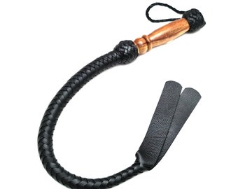 May include: A black leather bullwhip with a wooden handle and a braided leather tassel.