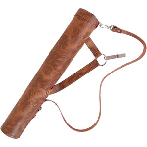 May include: A brown leather quiver with a textured pattern and a shoulder strap. The quiver is cylindrical and has a metal clasp and ring for the strap. The strap is adjustable and made of the same brown leather material.